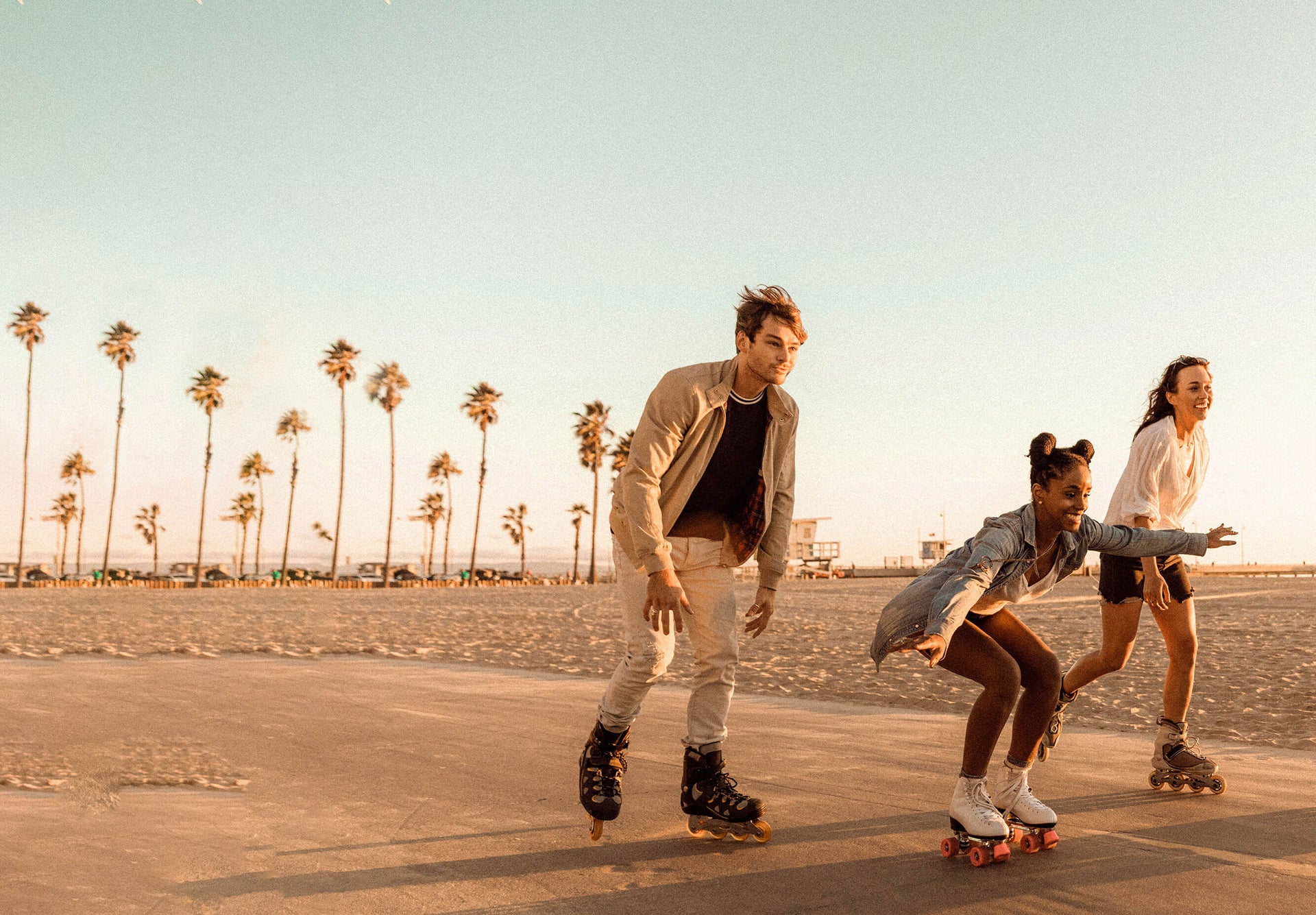 people rollerblading on beach